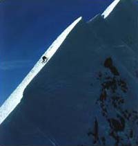 Climber on a large mountain side.