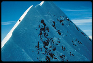 Climber on a large mountain side.